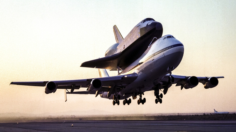 A modified Boeing 747 taking off with a space shuttle on top