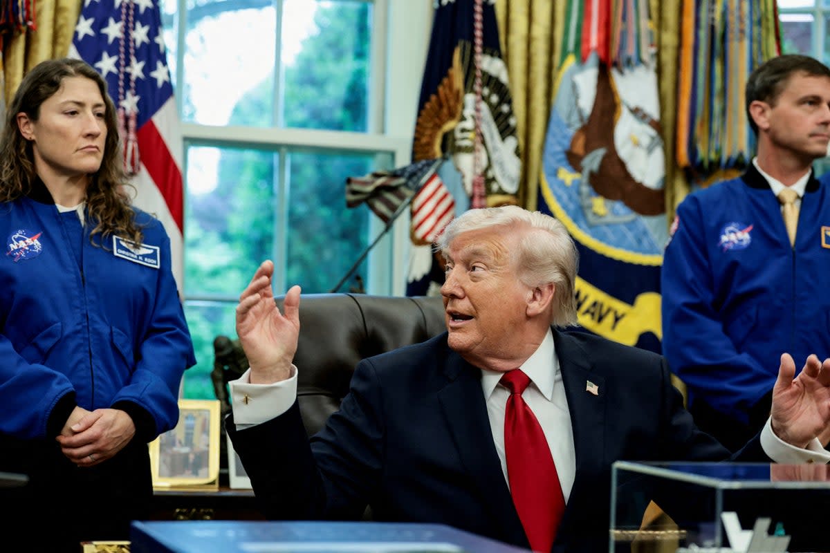 Artemis II astronauts, NASA Commander Reid Wiseman and NASA Mission Specialist Christina Koch, flank U.S. President Donald Trump as he speaks during an event in the Oval Office at the White House in Washington, D.C., U.S., April 29, 2026. REUTERS/Evelyn Hockstein/File Photo (Reuters)