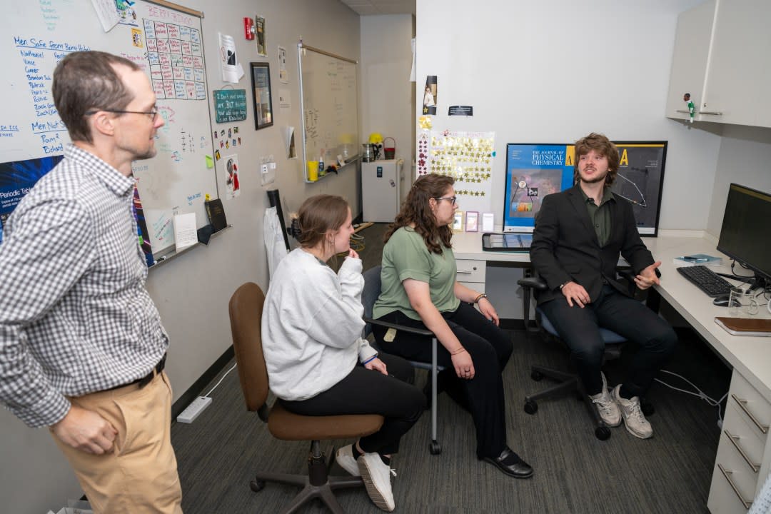 <em>Ryan Fortenberry (left), associate professor of chemistry and biochemistry at the University of Mississippi, speaks with students in his astrochemistry lab. NASA has awarded Fortenberry two grants to study how space dust forms and to explore how to break extraterrestrial rocks down to produce water. Photo by Srijita Chattopadhyay/Ole Miss Digital Imaging Services</em>