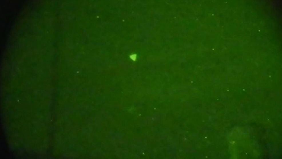 This U.S. Navy image shows a UAP captured through night vision goggles and a single lens reflex camera during naval exercises off the East Coast in early 2022. Based on additional information and data from other UAP sightings, the UAP in this image was subsequently reclassified as an unmanned aerial system. (Courtesy photo U.S. Navy via DVIDS)