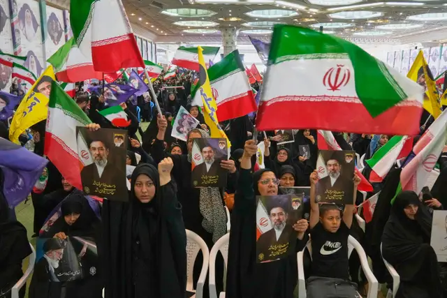 Government supporters hold Iranian flags and pictures of Iran’s Supreme Leader, Ayatollah Mojtaba Khamenei, during a ceremony honouring the armed forces and those killed in the war with Israel and the US at the Imam Khomeini Grand Mosque in Tehran on Sunday