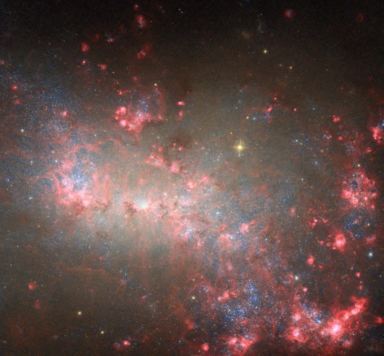 <em>Dust and gas fill the space between stars and galaxies and form the building blocks of all bodies in the universe. This image of the nearby galaxy NGC 4449 was captured by the NASA/ESA Hubble Space Telescope. Interstellar dust is the focus of University of Mississippi chemistry professor Ryan Fortenberry’s upcoming research. Photo courtesy NASA</em>