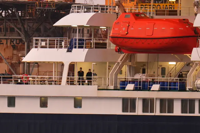 A view of the MV Hondius, with passengers wearing facemasks visible on the deck