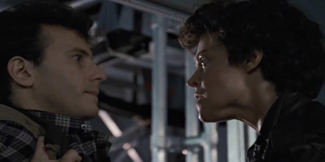 Ripley (Sigourney Weaver) seizes Burke (Paul Reiser) by the collar in 'Aliens' (1986)