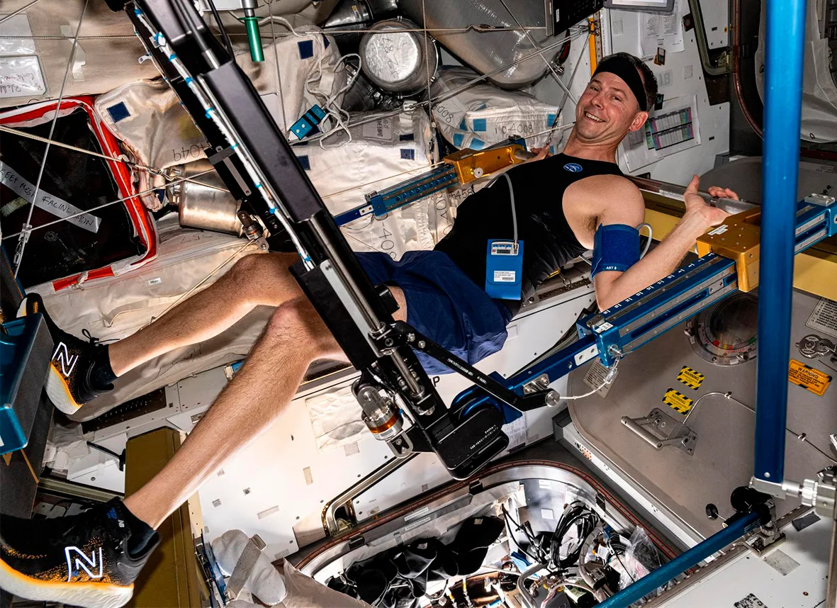 Astronaut Nick Hague exercises on the advanced resistive exercise device that mimics the inertial forces of lifting free weights on Earth