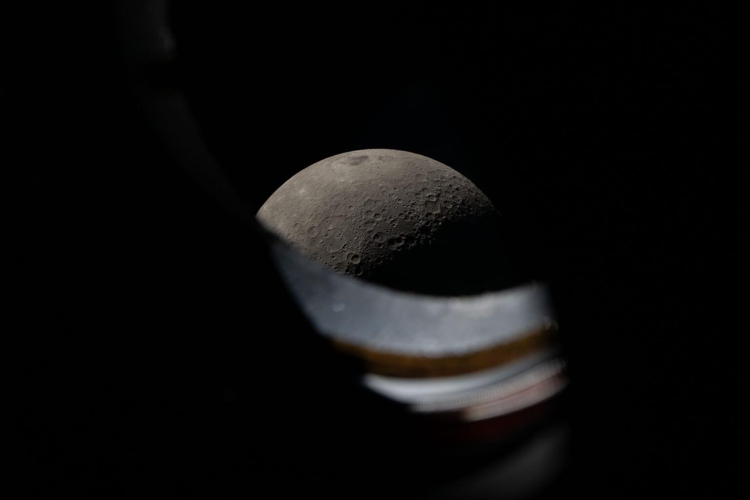 The Moon seen peeking above the window sill