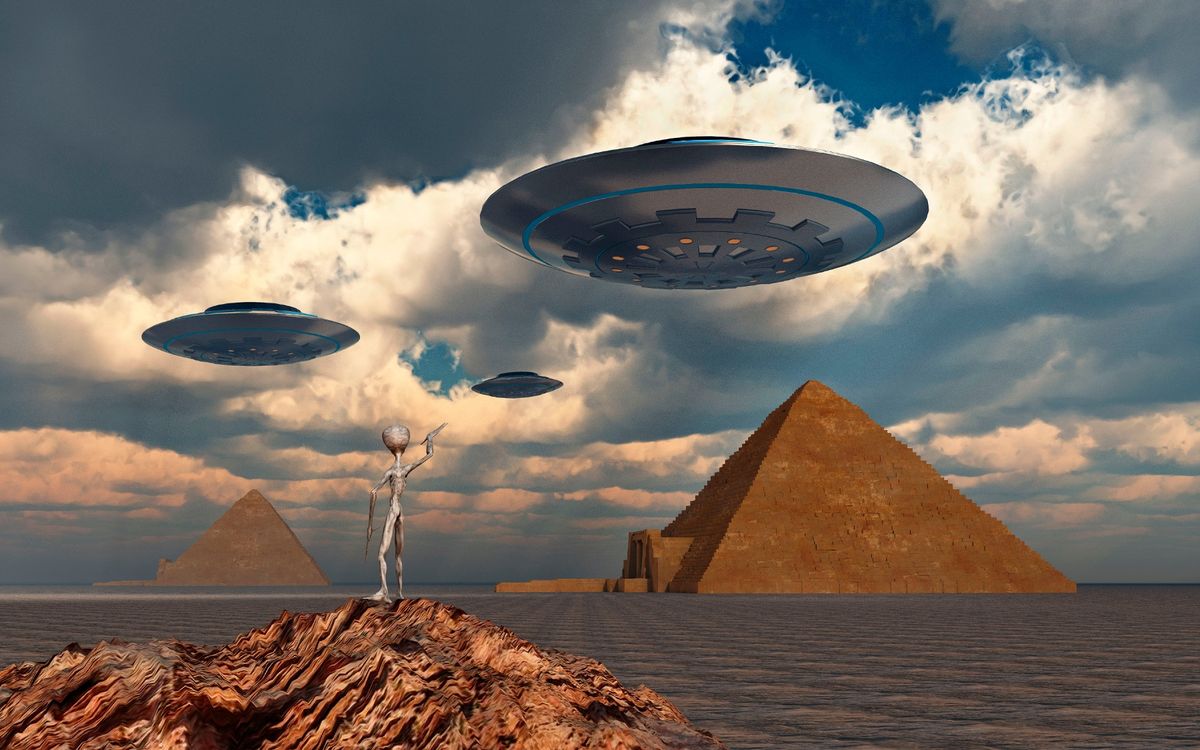 Alien space ships flying over the pyramids of Egypt
