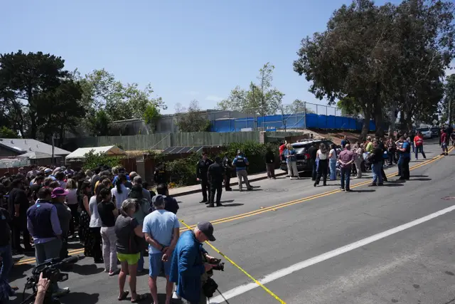 A crowd gathers near the scene of the shooting in San Diego