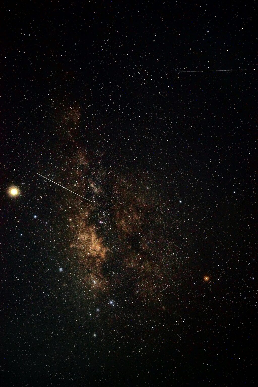 Deep sky dust lanes and a passing satellite.