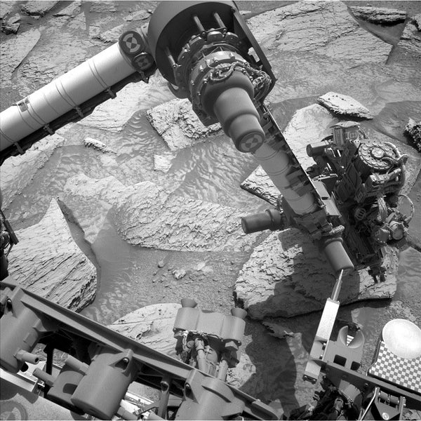 Gif of Curiosity attempting to shake a Martian rock loose