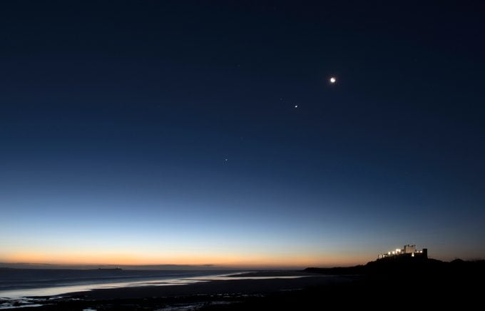 Bamburgh Castle, Northumberland, at Dawn with The Moon, Jupiter and Venus Overhead