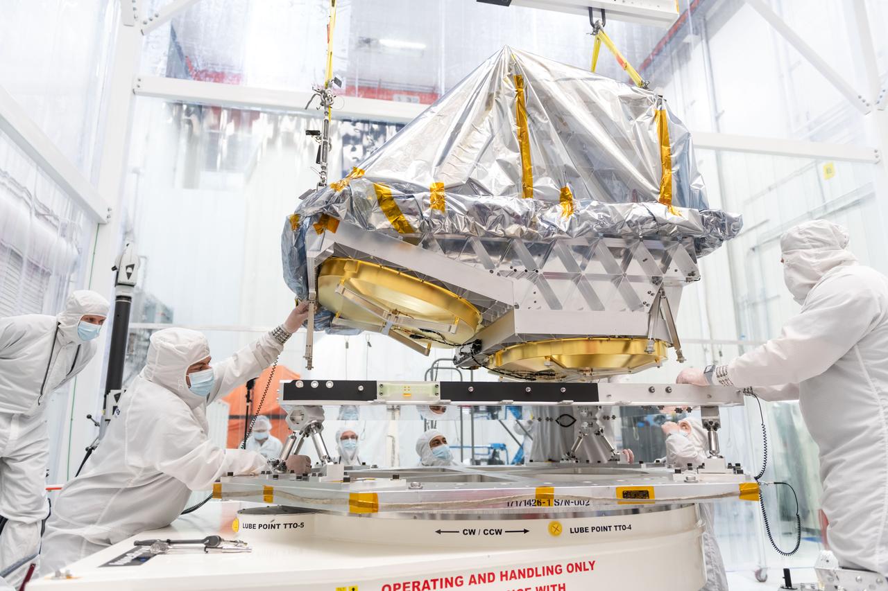 Engineers attach the aluminum telescope for NASA’s NEO Surveyor to the flight base frame at Space Dynamics Laboratory in Logan, Utah, last September. The telescope is the first specifically designed for planetary defense