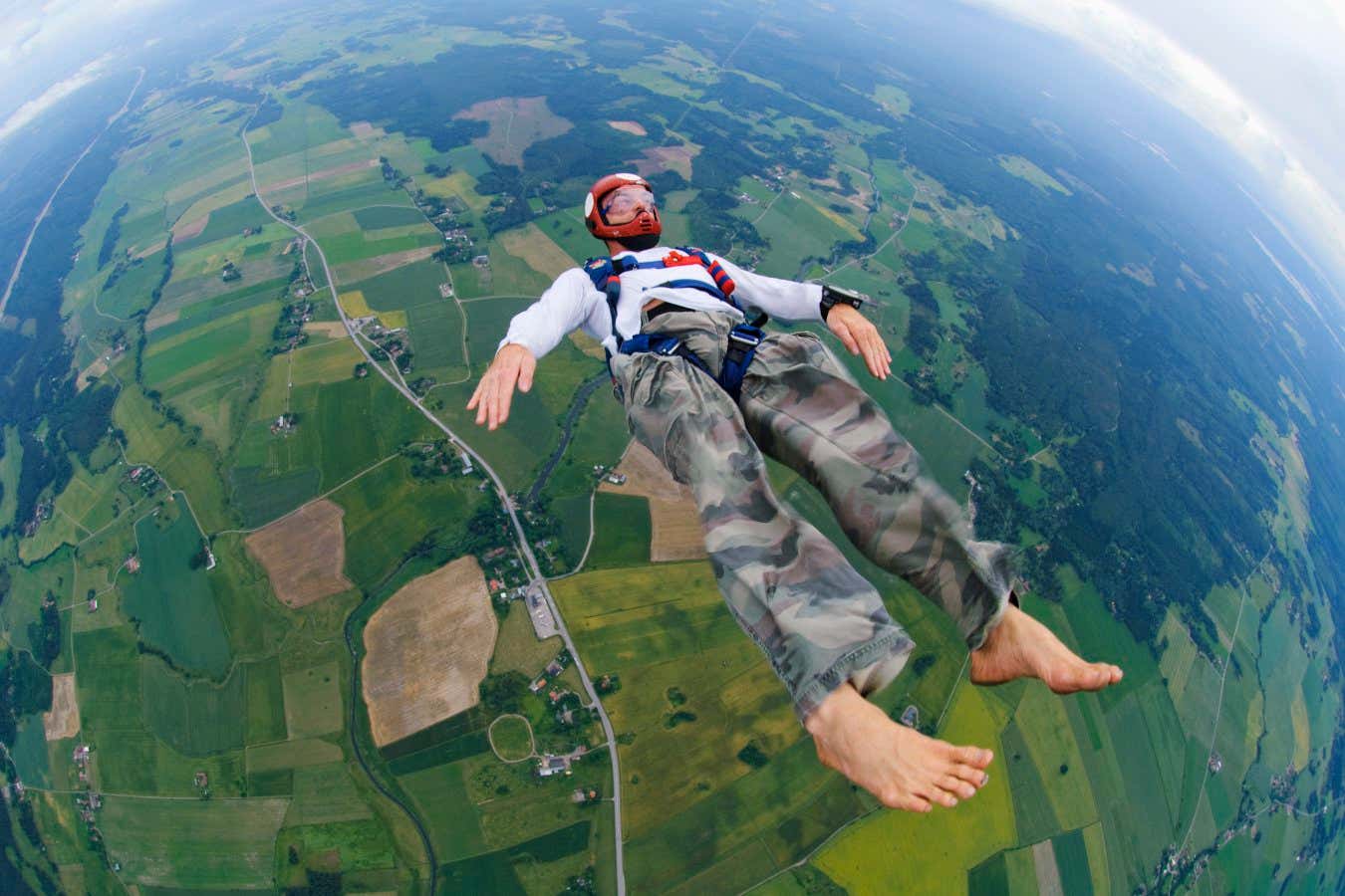 A skydiver, skydiving