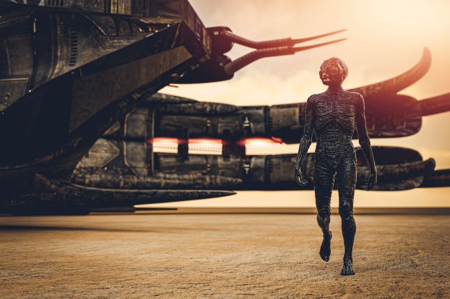 Alien with spaceship, walking in desert.