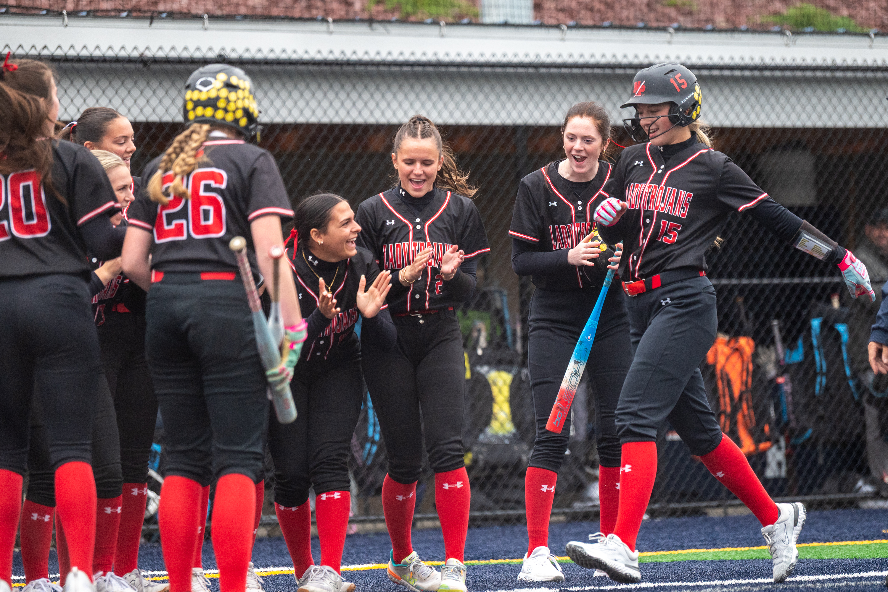 North Pocono players greet teammate Avarie Roscioli at home plate...