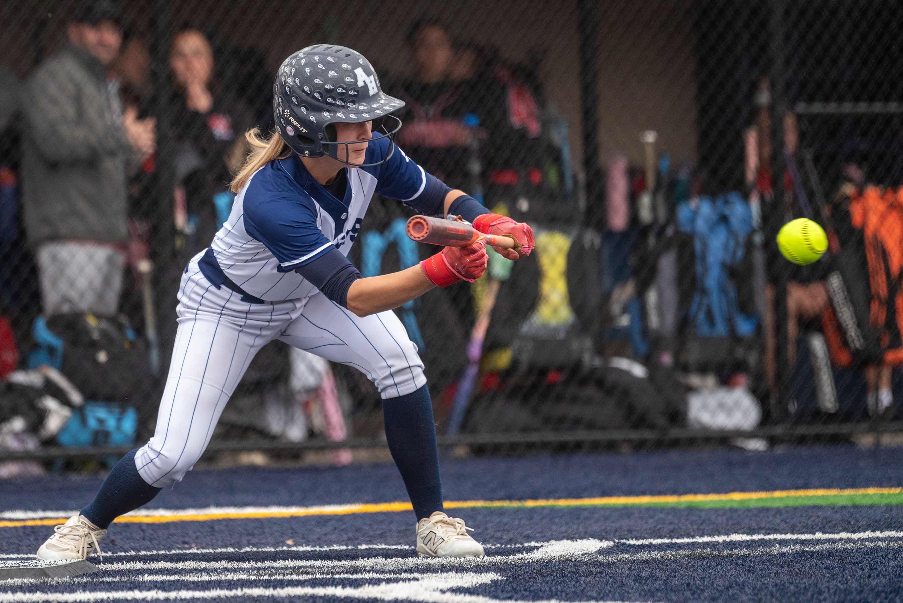 Abington Heights’ Riley McColligan bunts the ball during the softball...