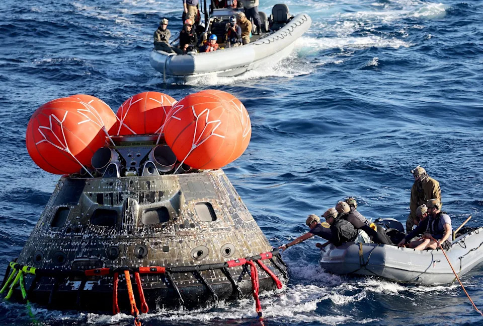 US Navy divers secure NASA's Orion Capsule during recovery operations following a successful uncrewed Artemis I moon mission after it splashed down in the Pacific Ocean off the coast of Baja California, Mexico, on December 11, 2022. Orion was launched November 16 on the Artemis rocket for a 25-day mission to the Moon. The main goal of this mission was to test Orion's heat shield -- for the day when it is humans and not test mannequins riding inside.