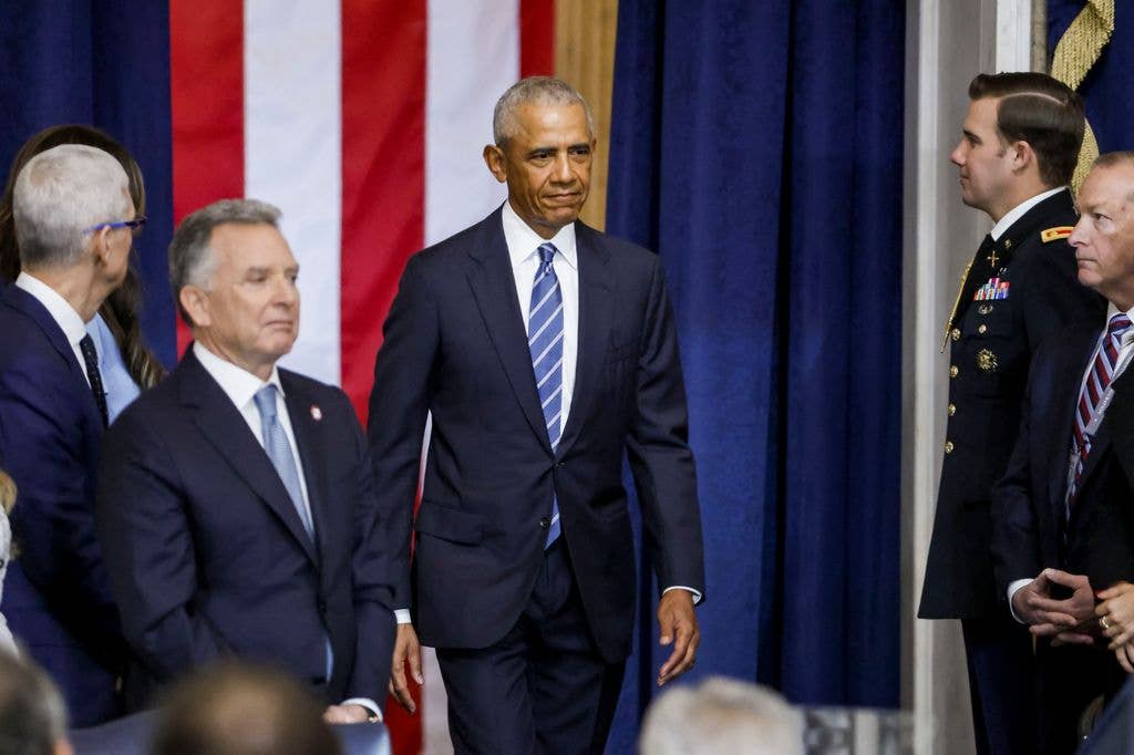 Former US President Barack Obama (C) arrives for the inauguration ceremony 