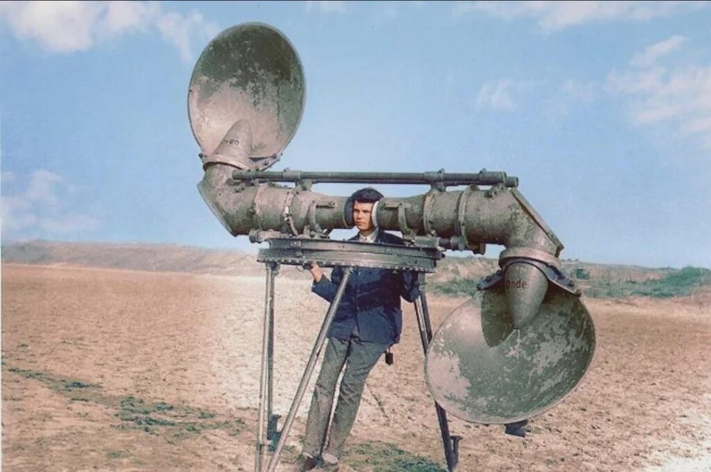 An “Aircraft Listener” photographed in the 1920s using a device with scoop-shaped reflectors which direct the sound into large-diameter tubes in order to try and locate aircraft at a distance from the sound of their loud engines before the advent of radar An "Aircraft Listener" photographed in the 1920s using a device with scoop-shaped reflectors which direct the sound into large-diameter tubes in order to try and locate aircraft at a distance from the sound of their loud engines before the advent of radar