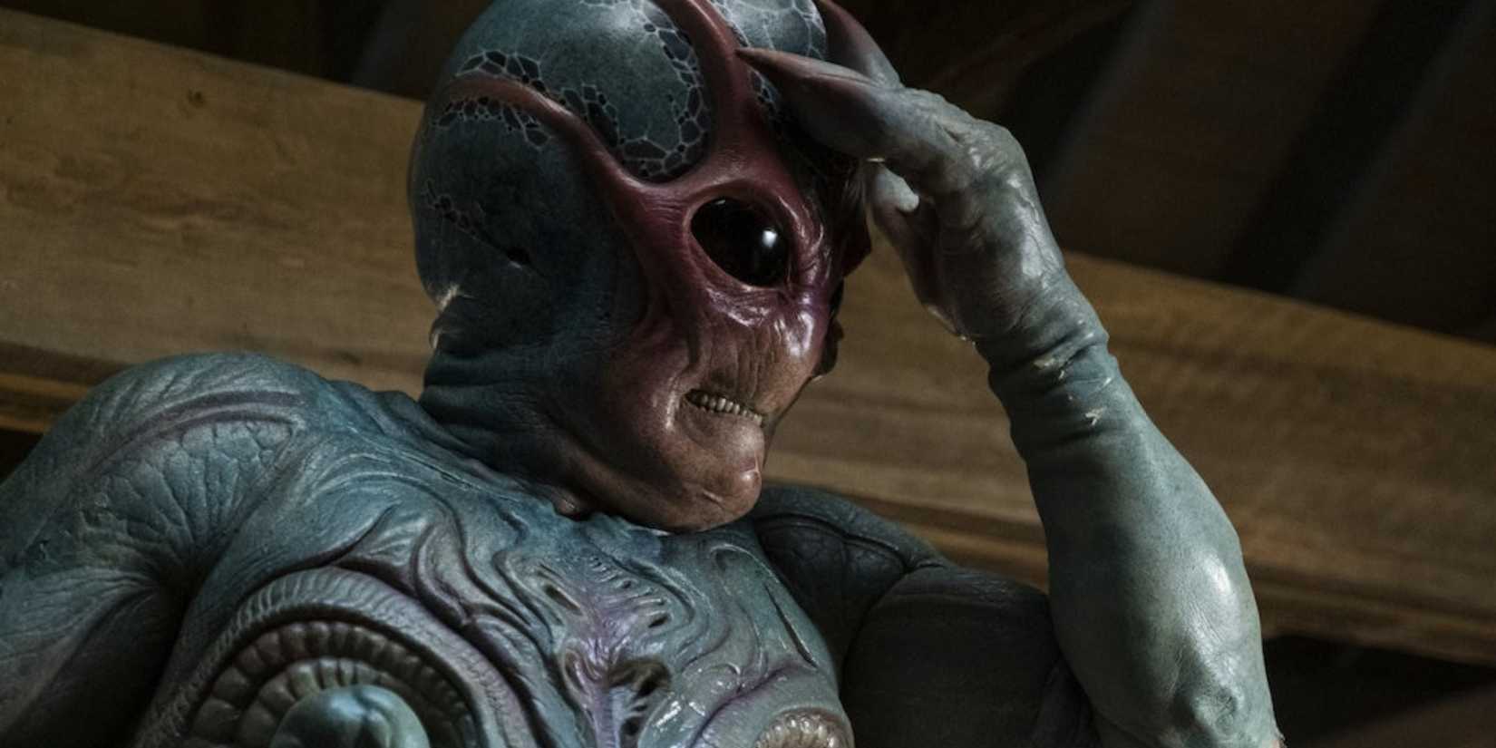 Harry in alien form rubbing his forehead in Resident Alien