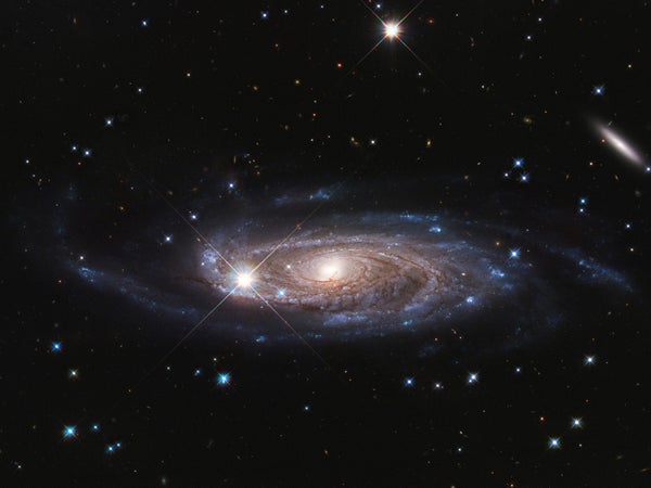 A photograph of a giant spiral galaxy in deep space
