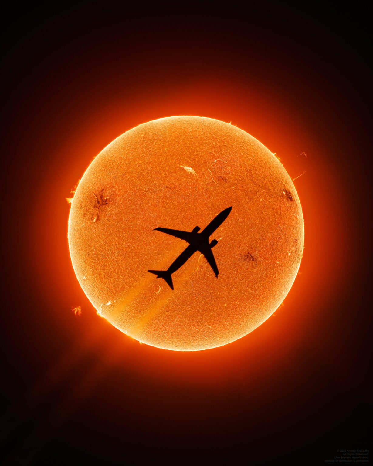 From Andrew McCarthy: "I took 1.7 million photos over 6 days to catch this photo of a commercial jet in front of the Sun. The moment it happened, 2 floating prominences were visible,making this not just my best aircraft transit photo,but one of the luckiest of my career!"