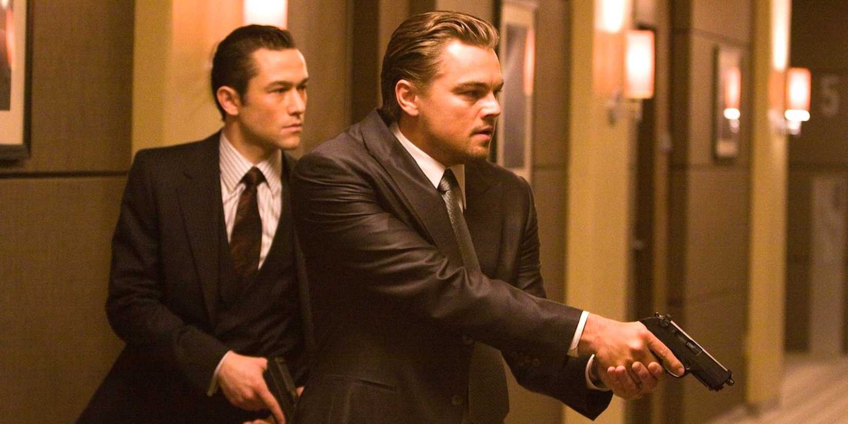Joseph Gordon Levitt and Leonardo DiCaprio holding guns in Inception 