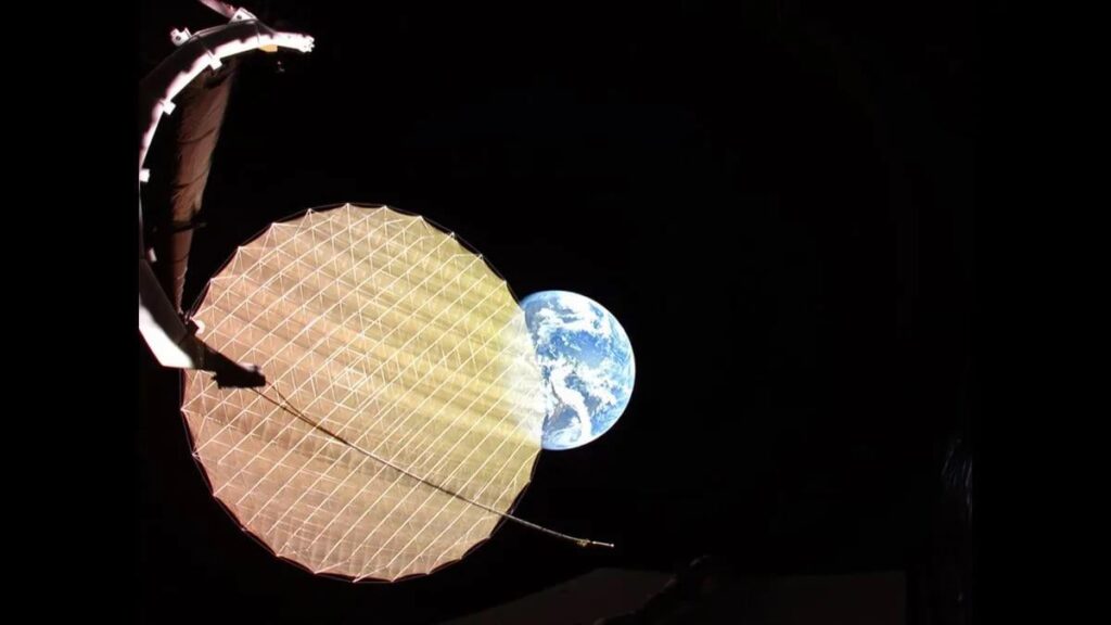 Earth photobombs ViaSat-3 F2 as it deploys its giant reflector in space.