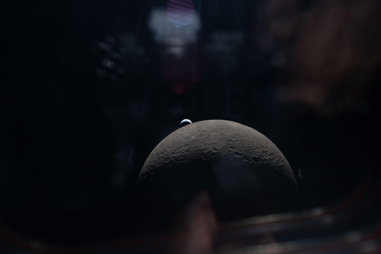 New image of a crescent Earth and the Moon from Artemis II, captured from inside the spacecraft.