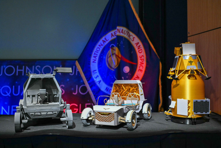 Models of lunar rovers and landers are displayed during a news conference at NASA headquarters in Washington, DC, on May 26, 2026, to outline plans for NASA's "Moon Base" lunar base and progress toward a sustained human presence on the Moon.
