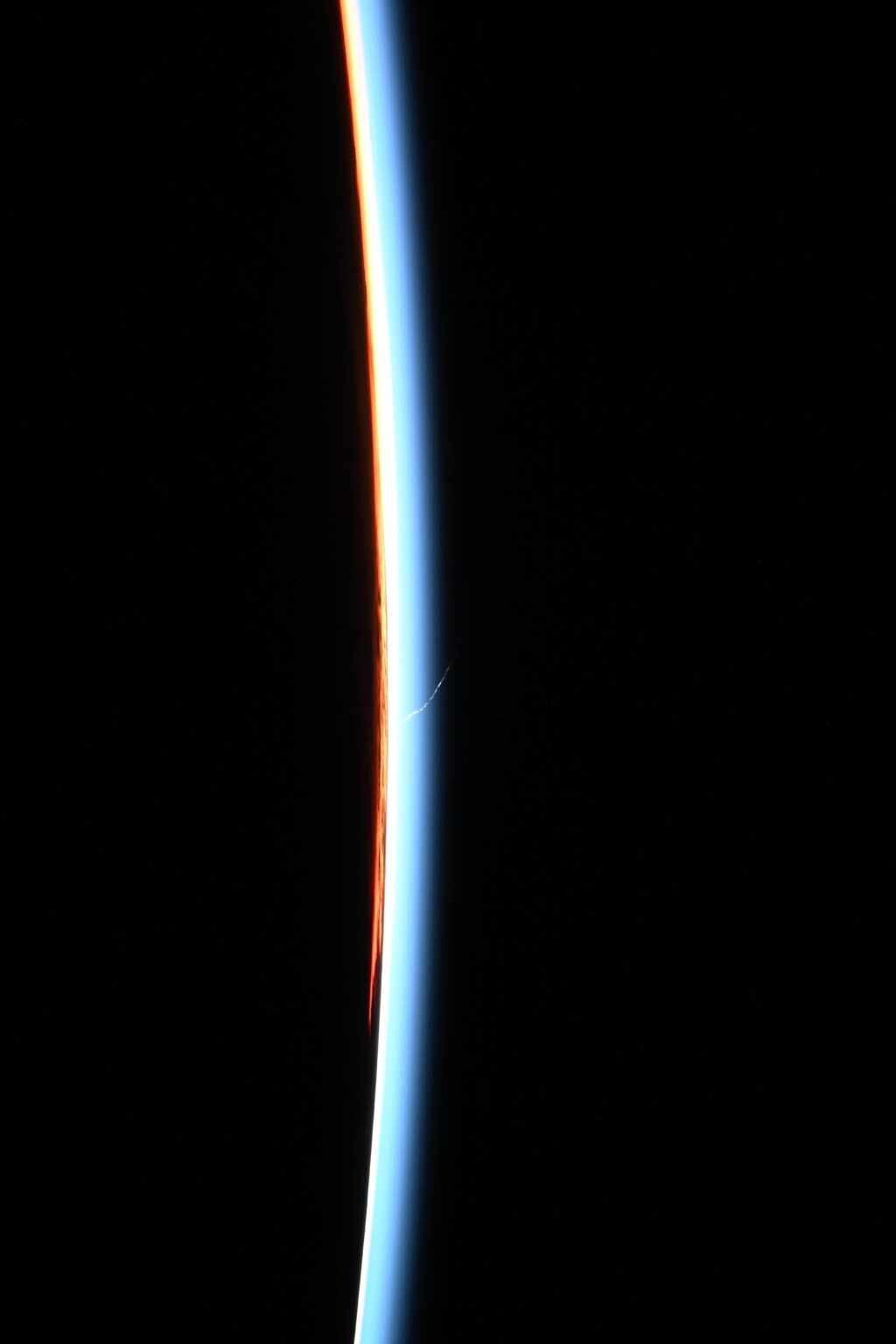 Falcon 9 launch seen from the ISS across Earth's twilight horizon