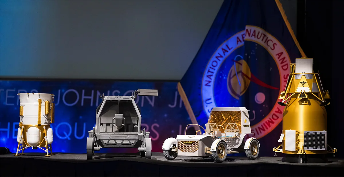 Models of some of the landers, rovers and orbiters NASA is planning to send to the Moon, as announced in May 2026. L-R: Blue Origin Mark 1 Lunar Lander, Astrolab Crewed Lunar Rover, Lunar Outpost Pegasus rover, Firely Elytra Dark orbiter. Credit: NASA/Aubrey Gemignani