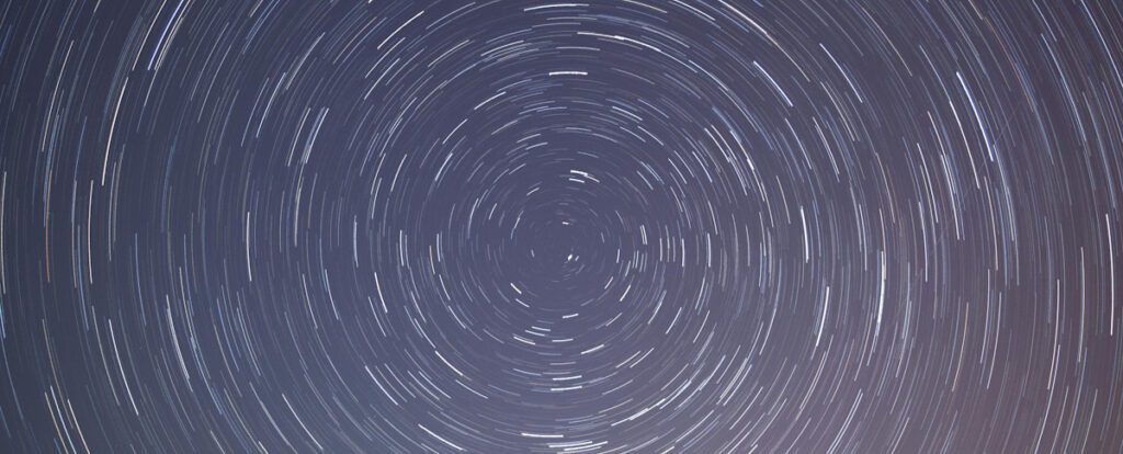 Talk: A brief history of the universe Swirling white dots on a dark blue background