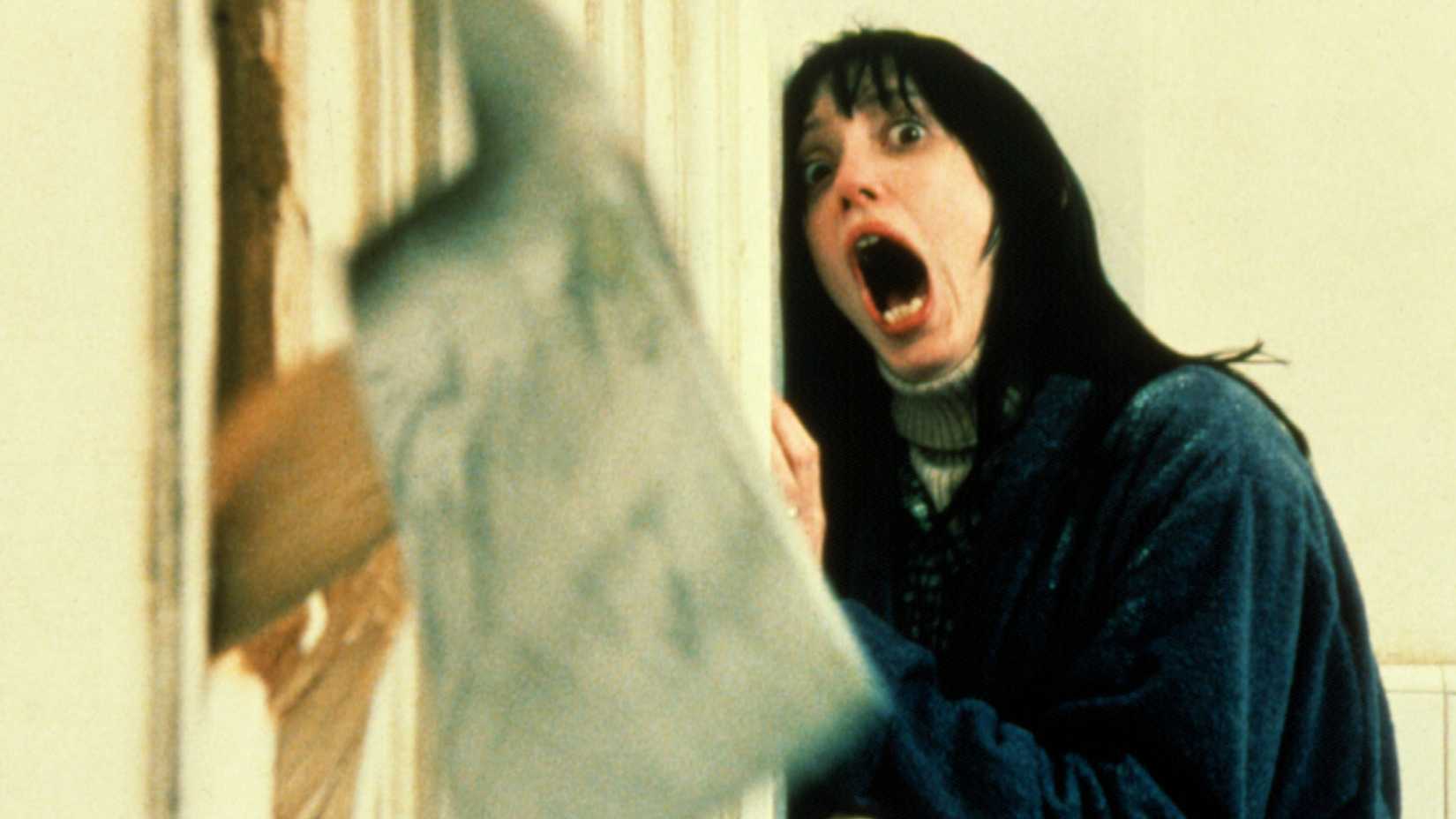Wendy (Shelley Duvall) screams as an axe breaks through the door in The Shining