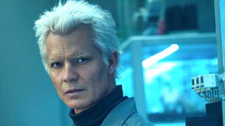 Timothy Olyphant's Kirsh looking curiously at something in Alien: Earth season 1