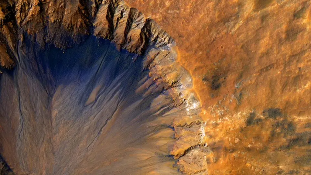 NASA’s Psyche Probe Completes Make-or-Break Mars Slingshot, On Course for Metal Asteroid in 2029 The top right corner of a Mars crater rim.