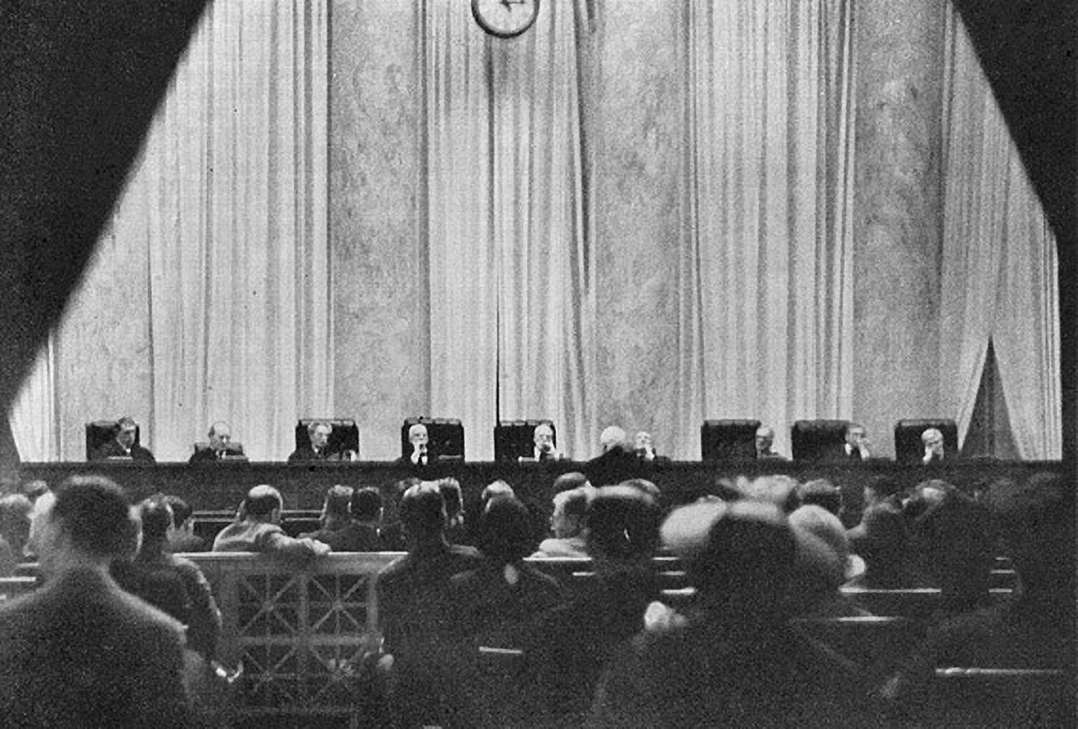 A woman's secret photograph of the U.S. Supreme Court in session, taken through a hole in her handbag, 1937.