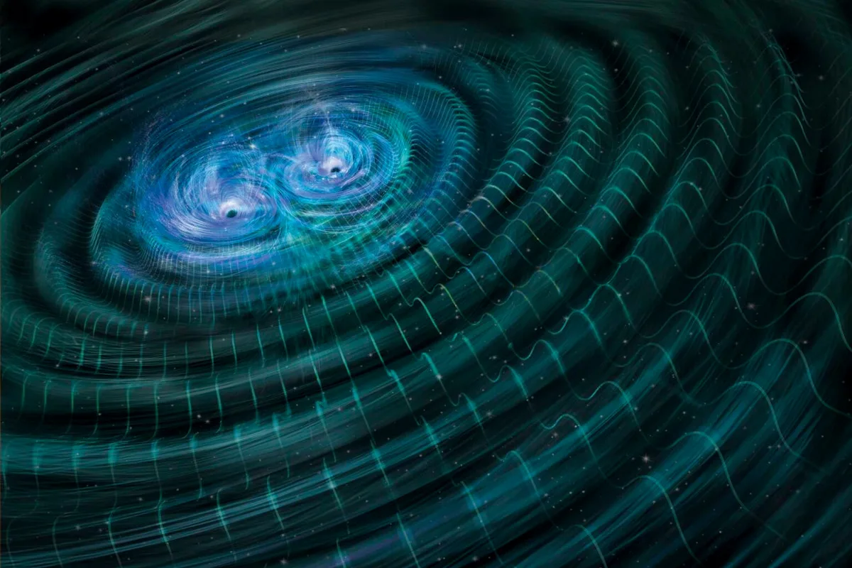 This illustration shows the merger of two black holes and the gravitational waves that ripple outward as the black holes spiral towards each other 