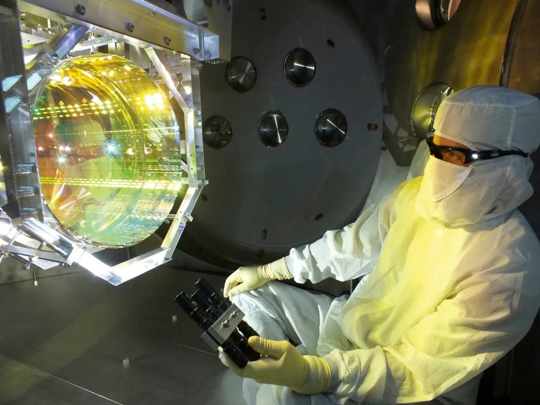A technician inspects one of LIGO’s four core mirrors, which help to measure distances affected by gravitational waves 