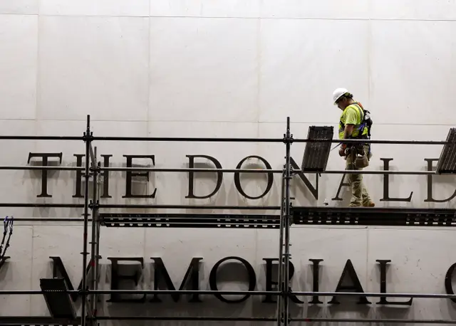 Workers erect scaffolding in front of the John F. Kennedy Centre