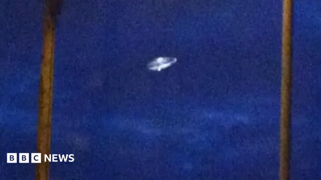 Does the UK have a blind spot on UFO sightings? An illustration showing a pair of couple going live on their social media channel, who are surrounded by sad-looking young people handing their hearts and some flowers to the influencers