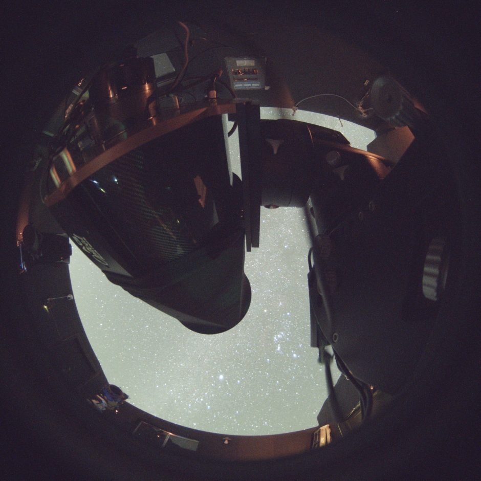 telescope and camera system track the constellation Orion beneath a clear winter night sky