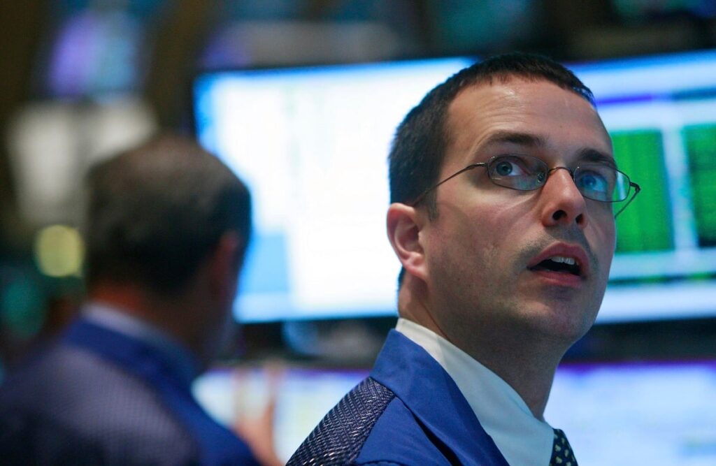 SpaceX Can Be Added to the Russell 1000 and Russell 3000 After Today – Don’t Take the Bait A New York Stock Exchange floor trader looking up in awe at a computer monitor.